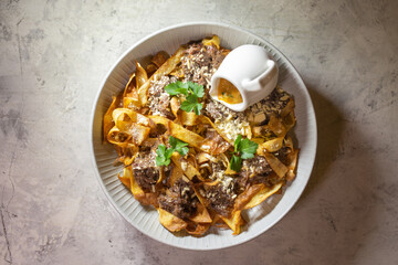 dough with pieces of meat. a dish in a restaurant.