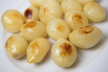 Preparing fresh white onions cooked on plate