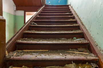 Wooden staircase without railings of the house abandoned by the residents. Destroyed by an...