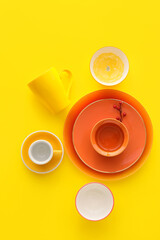 Obraz na płótnie Canvas Set of stylish dinnerware on yellow background
