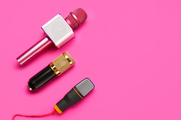 Different modern microphones on pink background