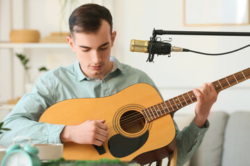 Guitar player recording his melody at home