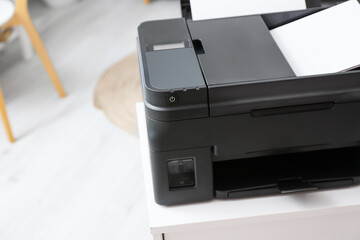 Modern printer on chest of drawers, closeup