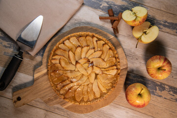 Delicious apple pie on a wooden table, from above
