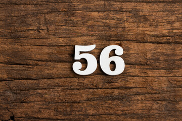 Number 56 - piece on rustic wood background