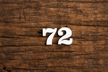 Number 72 - piece on rustic wood background