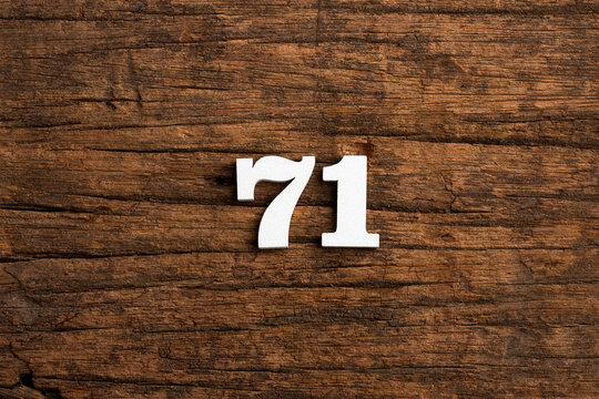 Number 71 in wood, isolated on rustic background