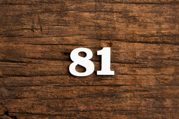Number 81 in wood, isolated on rustic background