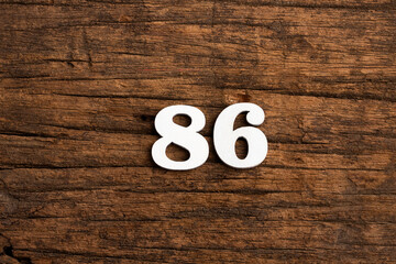 Number 86 - piece on rustic wood background