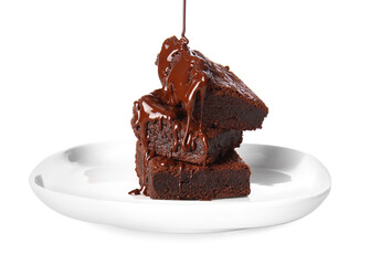 Pouring of chocolate topping onto plate with tasty brownies on white background
