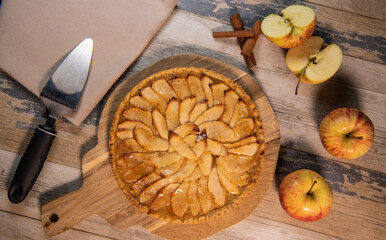 Delicious apple pie on a wooden table, from above