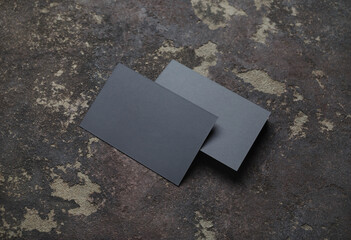 Blank gray business cards on concrete background. Responsive design template.