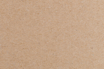Fiber texture of cardboard close-up. High-quality dense beige cardboard. Natural packaging material or creative material. Recycled paper