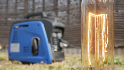 The incandescent lamp is powered by a gasoline generator - obrazy, fototapety, plakaty