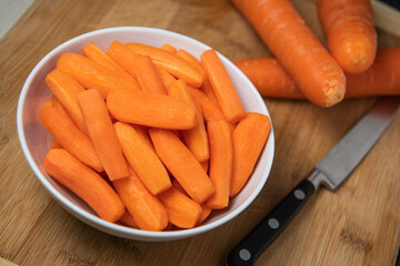 Preparing fresh carrots on wood table