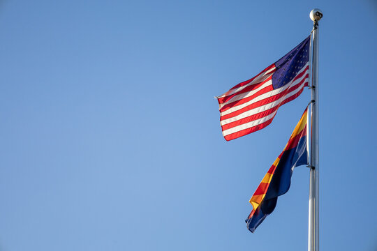 American And Arizona Flag Waving At Sunset