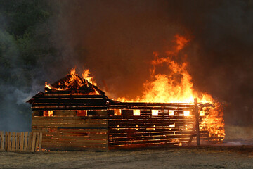 burning wooden building - Powered by Adobe