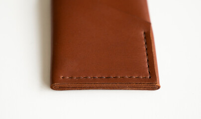 Empty men's business handmade leather card holder with isolated on white background. Selective focus, copy space, close up.