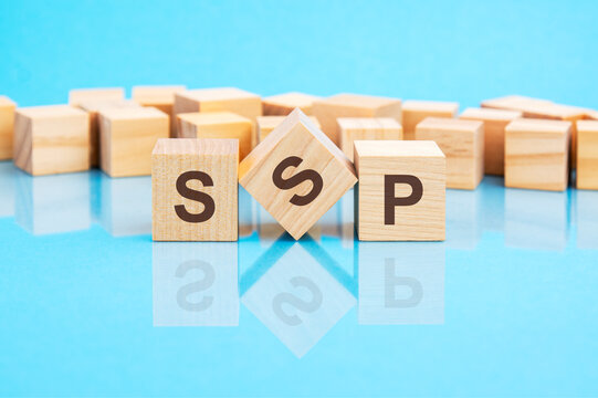 SSP text is made of wooden building blocks lying on the bright blue table, concept