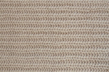 knitting background, hand knitting texture with soft warm natural yarn