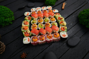 Above view of various sushi and rolls placed on stone board. Japanese food fest. Top view, flat lay.