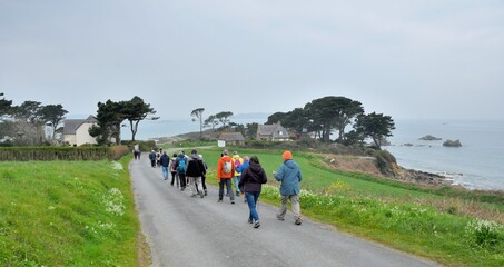 Group of senior hikers walking on a path in Brittany. France