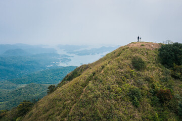 Fototapeta na wymiar Man hiking on peak of a mountain, trail footpath, Sai Kung, Hong Kong