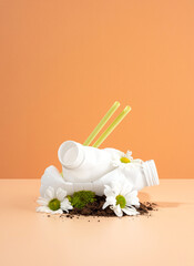 Negative impact on nature. Plastic bottles crush beautiful flowers growing in the ground. Soil pollution. The idea of plastic pollution. The concept of environmental damage. Creative composition