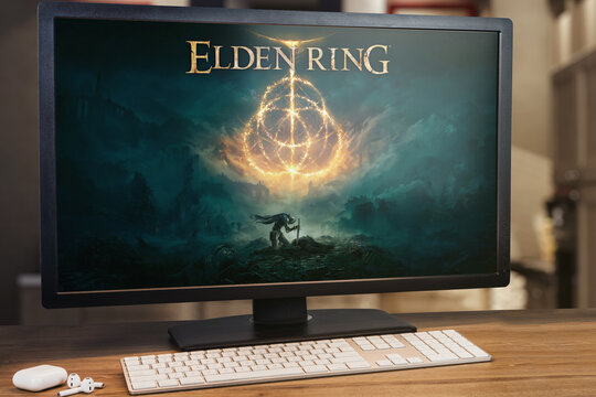 Elden Ring game on computer screen. Monitor, keyboard and airpods on wooden table. Selective focus. Rio de Janeiro, RJ, Brazil. March 2022
