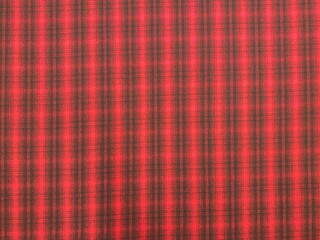 Natural wool fabric. Tartan plaid fabric pattern background textured. Close-up red fabric texture. Woolly plaid fabric.