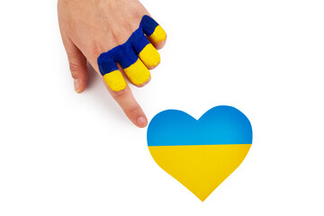 Female hand with Ukrainian flag touch heart of Ukraine on isolated white background. Concept of...