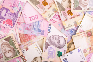 Ukrainian money and red stock chart arrow down, ukraine hryvnia is fall, economy crisis concept