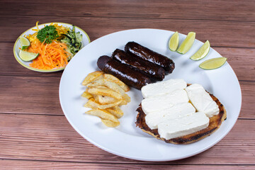 Traditional Colombian food, black pudding, chocolo arepa with cheese, salad, french fries and salad