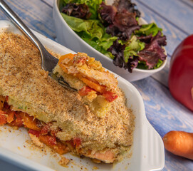 Salmon Parmentier recipe with hazelnuts, young salad leaves