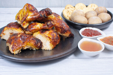 Roast chicken, traditional Colombian food, accompanied by boiled potato, arepa, sauces