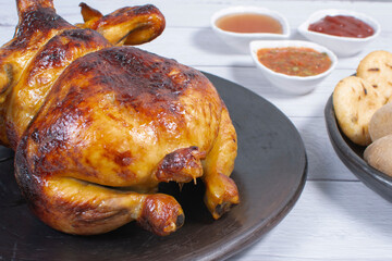 Roast chicken, traditional Colombian food, accompanied by boiled potato, arepa, sauces