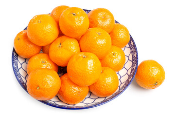 Fresh Organic Jeruk Baby Santang or Mandarin Baby Oranges, very sweet and juicy, serving on blue plate on white background. Clipping path