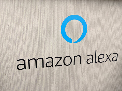 Amazon Alexa sign which is a Smart Assistant on a white wall display