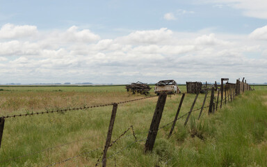 field, field wire and old truck on a farm