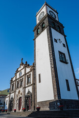 Fototapeta premium Perspective of bell and clock tower and Gothic and Manueline facade of São Sebastião Church in Ponta Delgada, São Miguel - Azores PORTUGAL