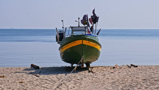 Fishing Vessel with Purse Sein Fishing Equipment Parked on Beach Sand at Seashore on Calm Dayse Seiner 