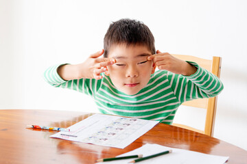 Little asian boy studying at home