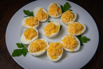 Stuffed eggs with crab crumbs, mayonnaise and parsley macro on a plate