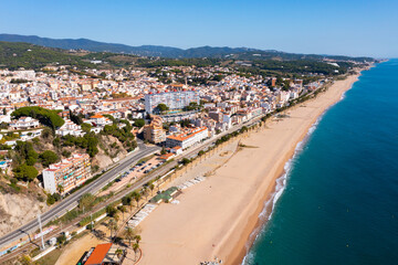 Fototapeta na wymiar Birds eye view of Canet de Mar, Spain. Residential building along Mediterranean sea coast and beach visible from above.