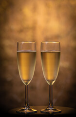 Champagne glasses over holiday bokeh blinking background, glasses with sparkling wine, celebration, party