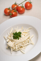 Celery Root Remoulade, classic bistro salad julienned celery root melds with a Dijon mustard dressing on a white plate, close-up