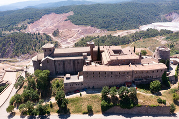 Picturesque aerial view of walled fortified castle of Cardona located on hill in Cardener river...