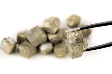 geologists use ore tongs to examine rare ores or silver or gold mined in a mine on a white...