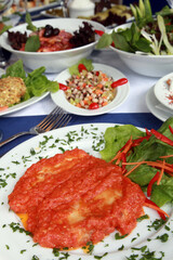 Perch Fish with tomato sauce and vegetables on the restaurant table.