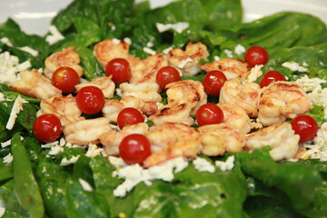 Shrimps and vegetables on the dinner plate.